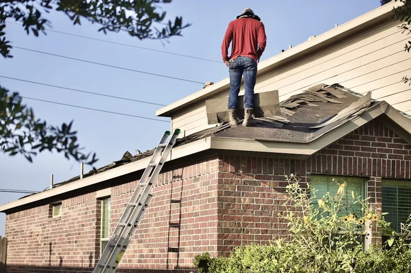 Professional roofer working on a residential roof in Ridge Park